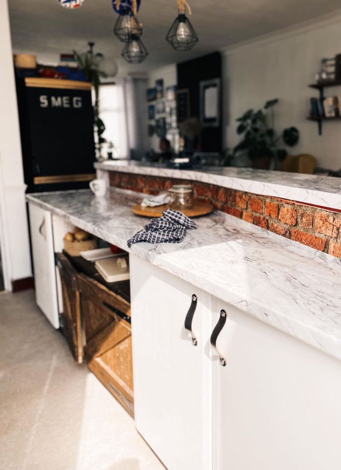 She used an old palette of wood to create doors on her kitchen island