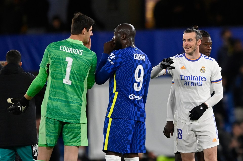 Chelsea sub Romelu Lukaku chats with Thibaut Courtois as Real replacement Gareth Bale looks on happily