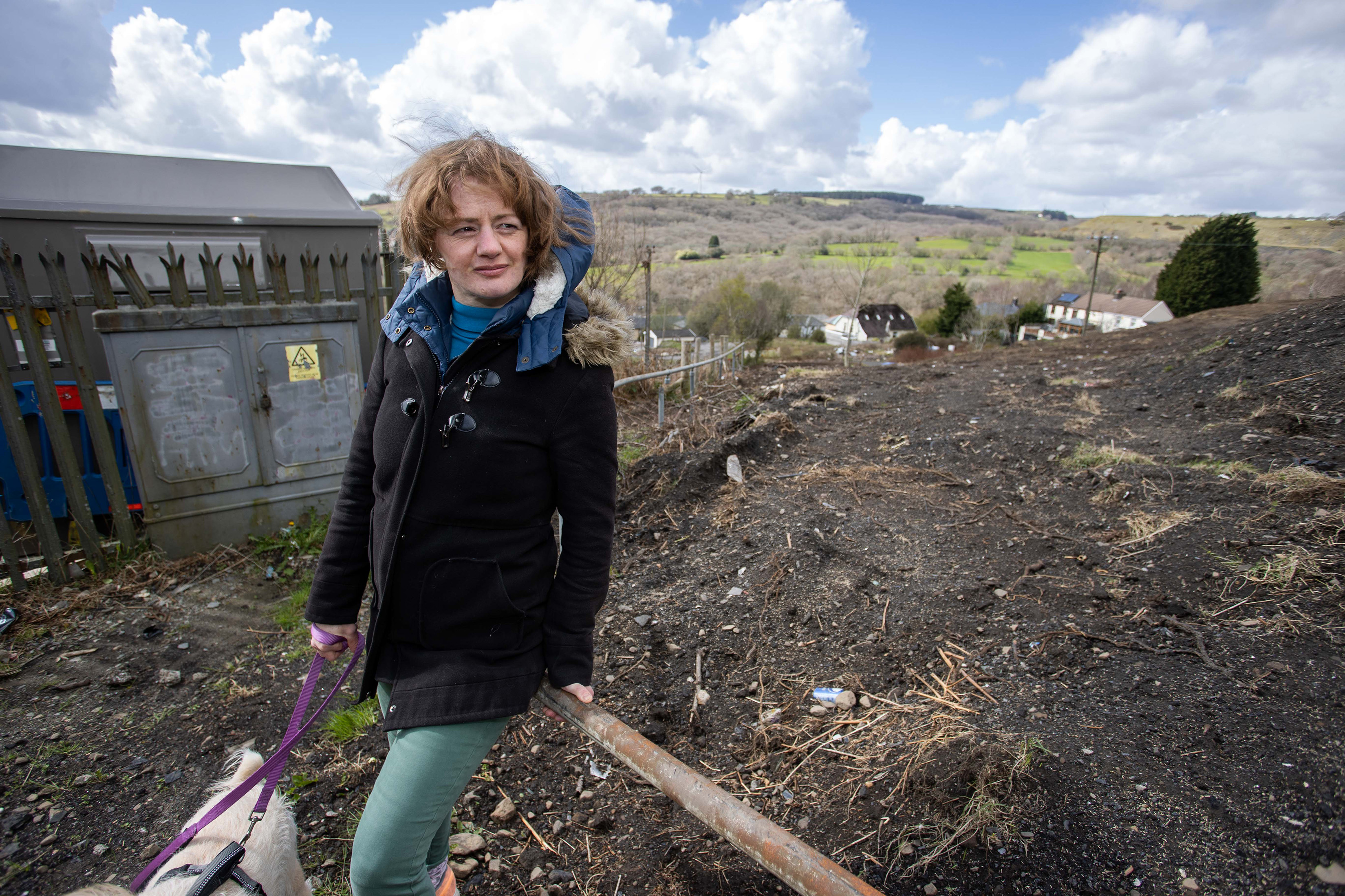 Angry resident Rebekah Stone with dog Snoopy by the earth-covered footpath