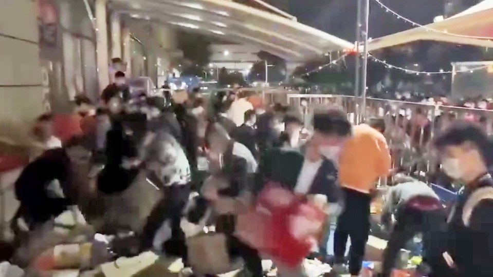 Shanghai residents have been filmed scouring a supermarket for food and other supplies