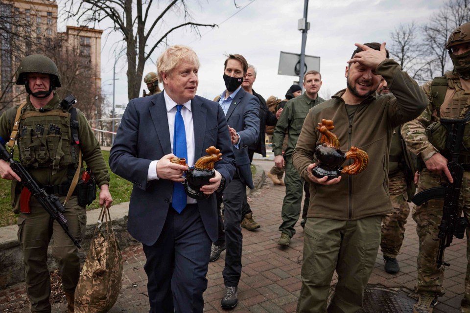 Chicken Kyiv – Zelensky Boris Johnson hold souvenirs presented by a civilian woman in Kyiv