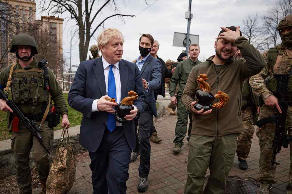 Chicken Kyiv - Zelensky Boris Johnson hold souvenirs presented by a civilian woman in Kyiv