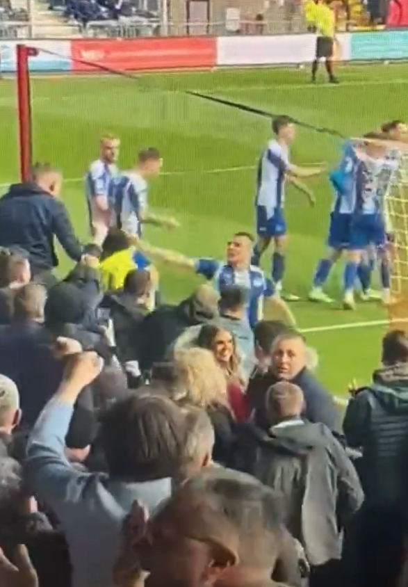 Max Power took a steward's hat whilst celebrating Wigan's goal against Lincoln City