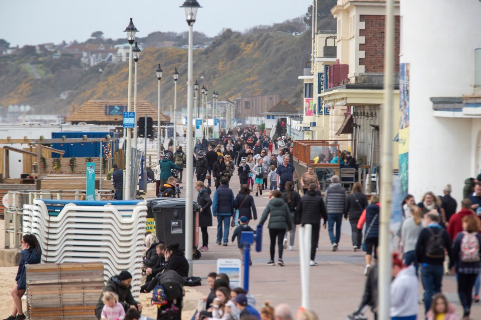 Families make the most of a blustery day on Bournemouth beach, Dorset