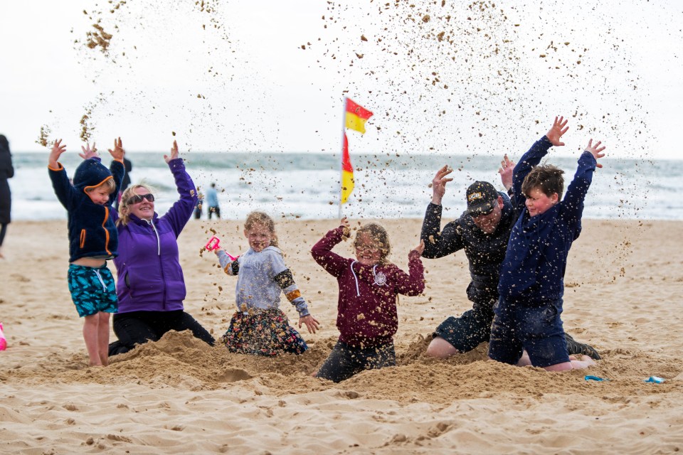 Brits (pictured in Bournemouth) can pack away the brollies ahead of the weekend - as the country is set to bask in a 22C Easter scorcher