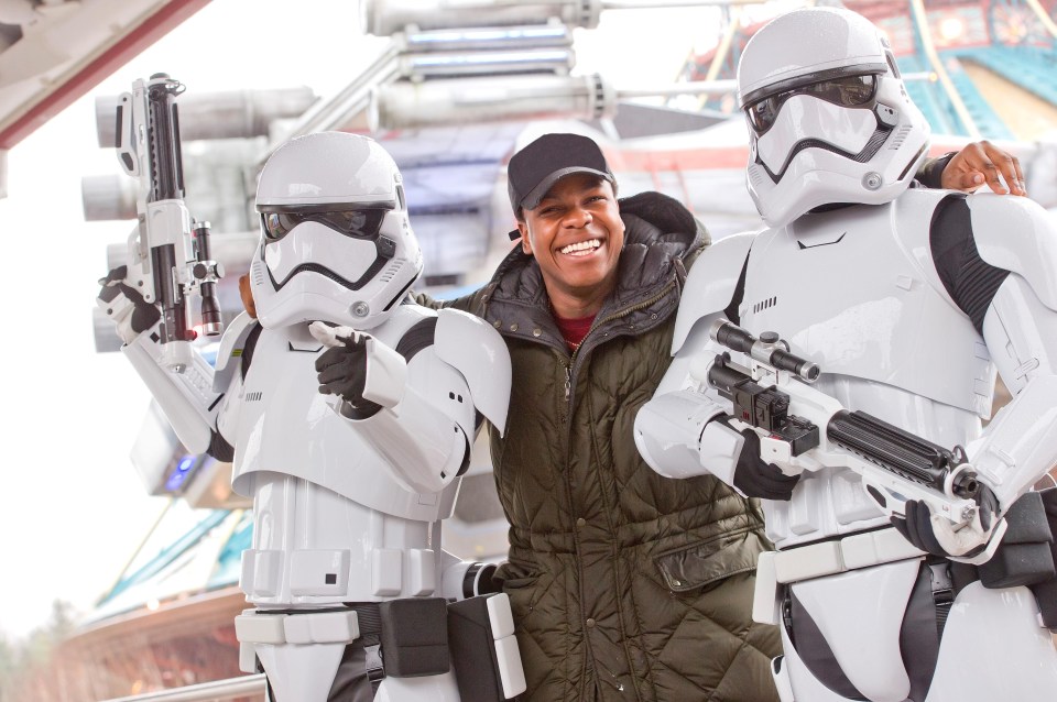 John Boyega posing with stormtroopers at the park