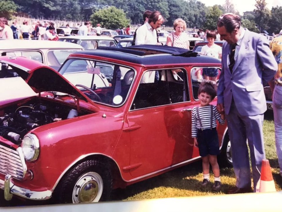 This photo shows John Cooper – the man behind one of the most iconic British cars ever, the Mini Cooper – with his grandson Charlie