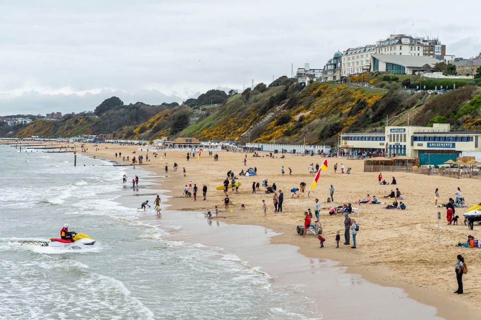 People make the most of milder temperatures and head to the beach in Bournemouth, Dorset, as the Easter holidays continue