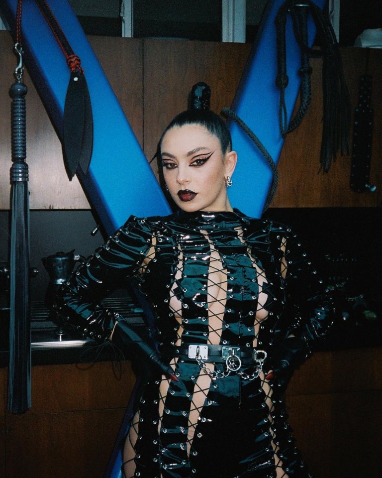 Charli wears this raunchy leather and string outfit, complete with a lock on the front, in the video to her song Used To Know Me