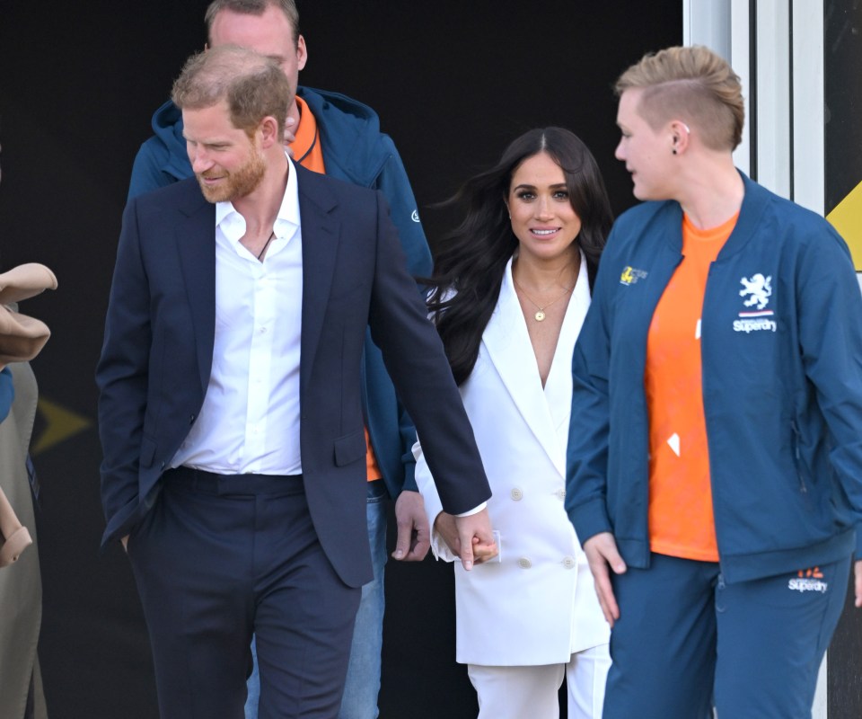 The Sussexes holding hands as they arrive at the reception at Zuiderpark in The Hague, Netherlands