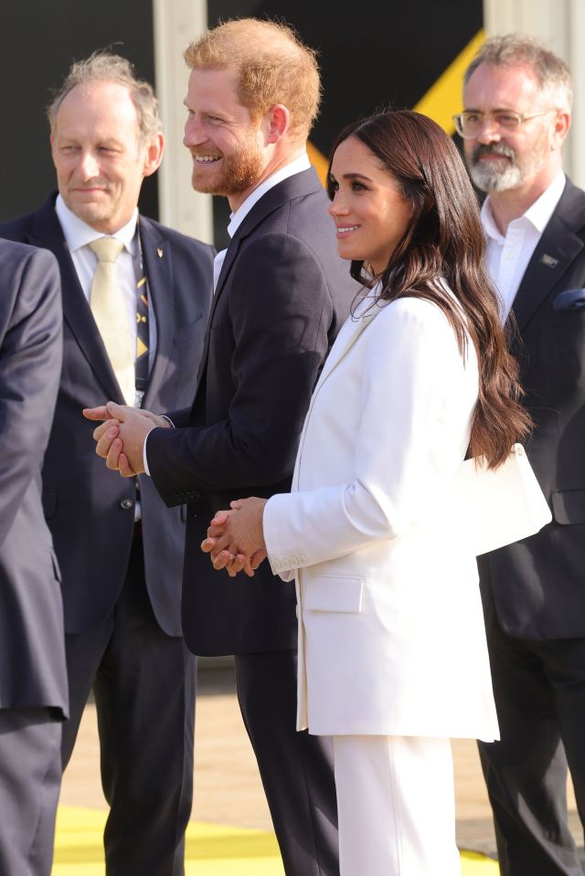 She and Harry smiled as they were welcomed for the event this weekend