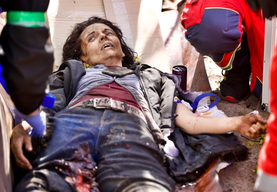 Medics tend to a woman who fell victim to a Russian missile strike in Kharkiv