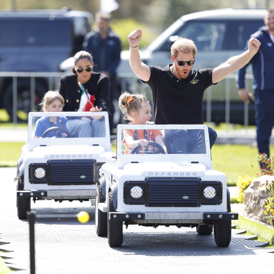 Meghan — dressed down in blue jeans, white top, black jacket and sunglasses — clutched Canadian and French flags as she was driven by Mya Poiret, four