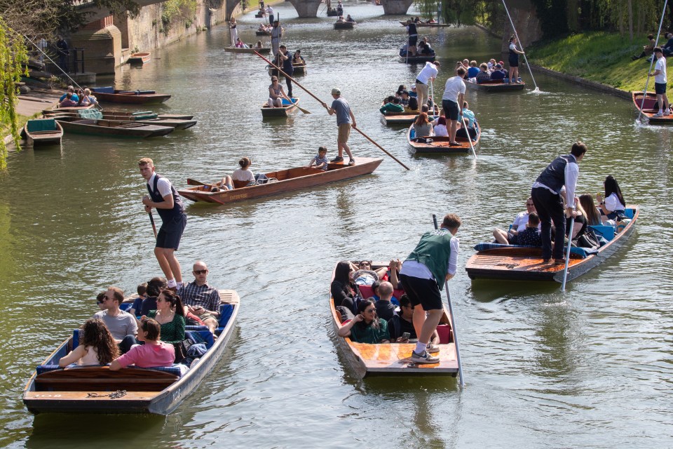 People enjoying the hot weather out punting on a busy River Cam in Cambridge