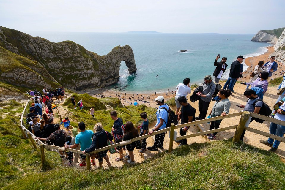 Sunseekers flocked to Durdle Door in Dorset yesterday