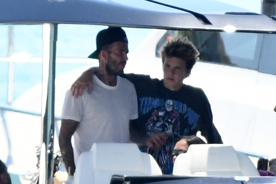 Cruz Beckham gave his dad David a hug as they celebrated his mum Victoria's birthday