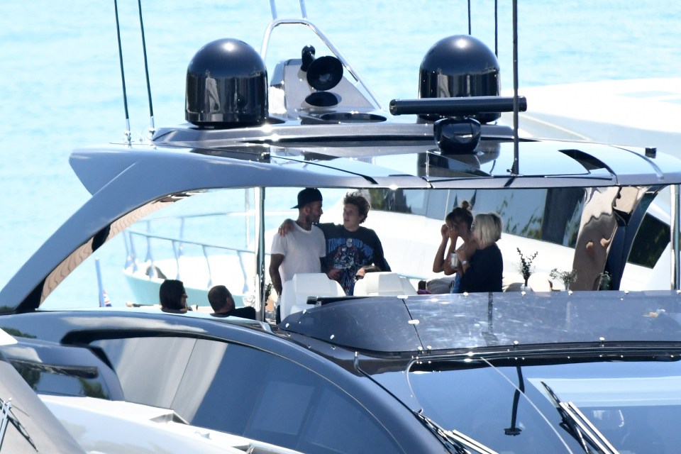 The father son duo looked very close as they chatted on the yacht