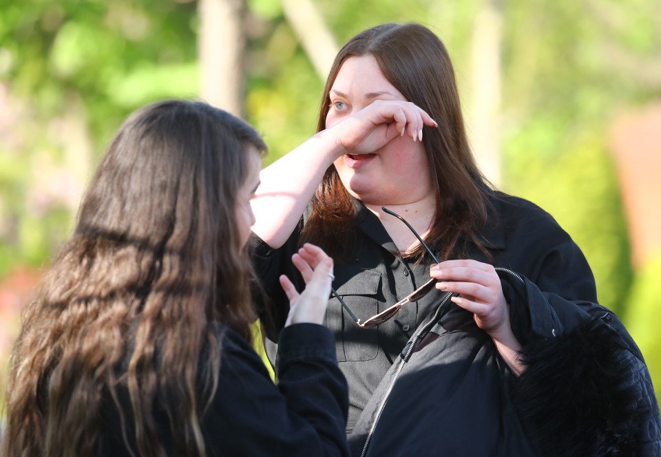 A fan wipes tears away as Tom makes his final journey