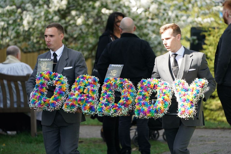 A wreath spelling 'Daddy' is taken into the church