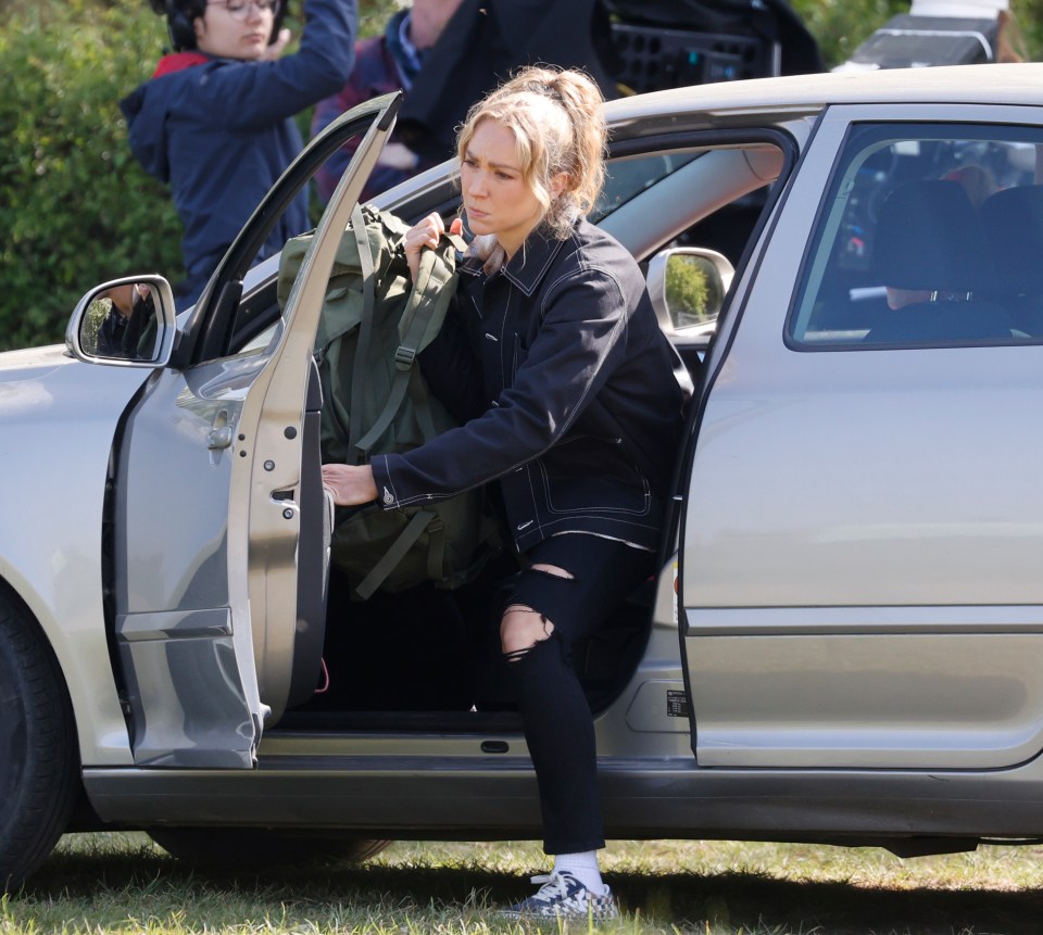 Nancy is then seen getting out of the car with a large green backpack