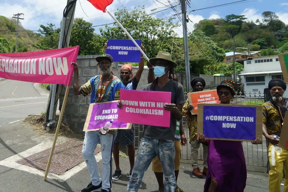 But a group of around 15 protesters displayed placards including 'end to colonialism' as the couple made their way to Government House