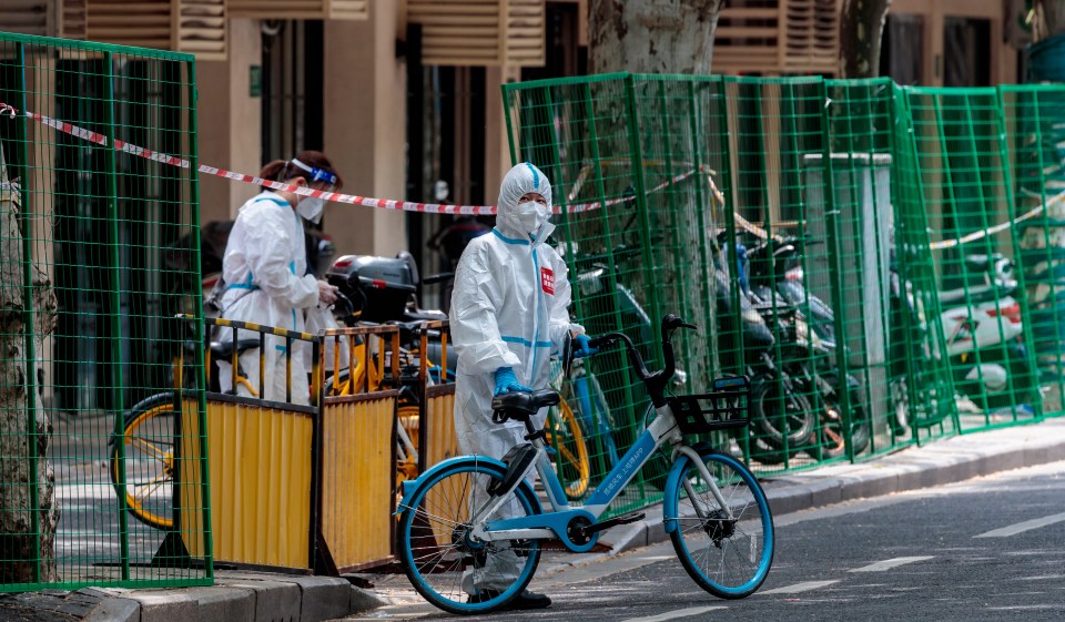 Officials erected green barriers to keep people inside in order to curb the spread of Covid