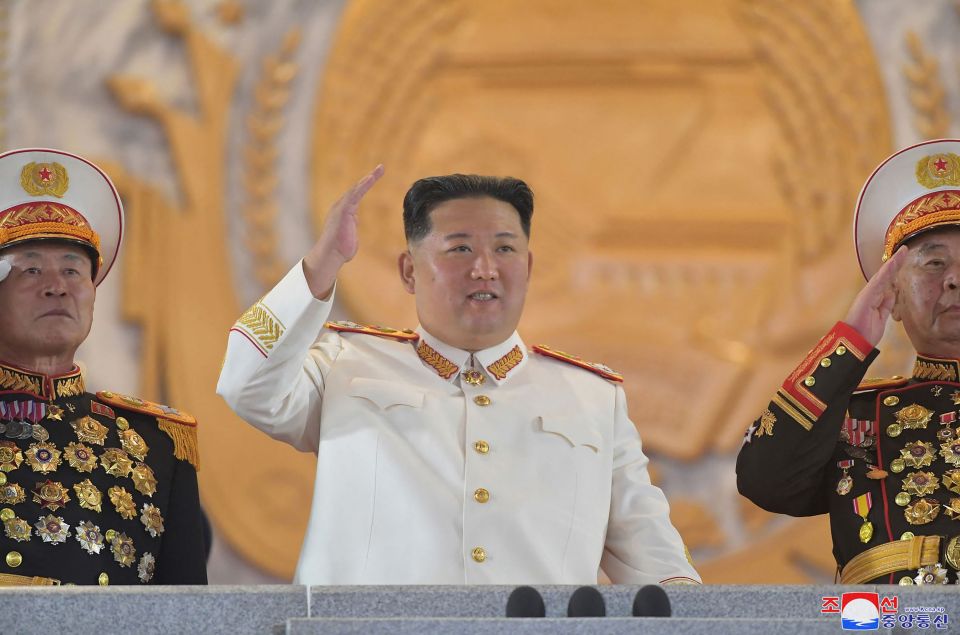 Kim Jong-un wore white and waved as he oversaw the parade