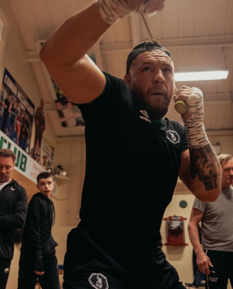 He gets in some shadow boxing using small weights