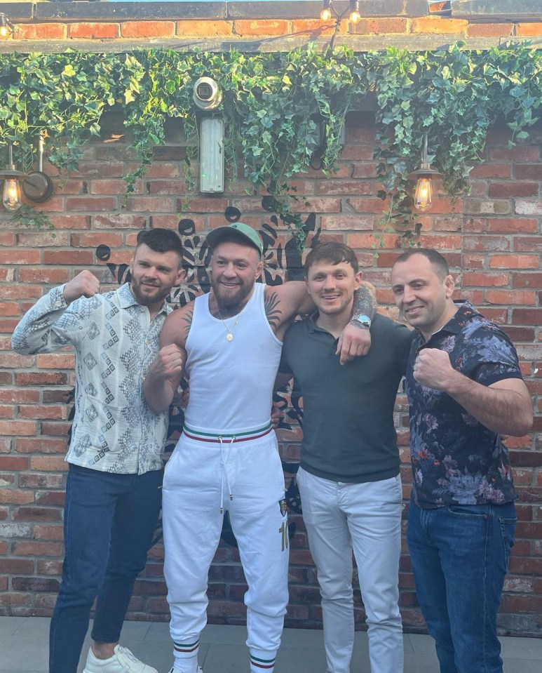 McGregor poses with pals after his workout session