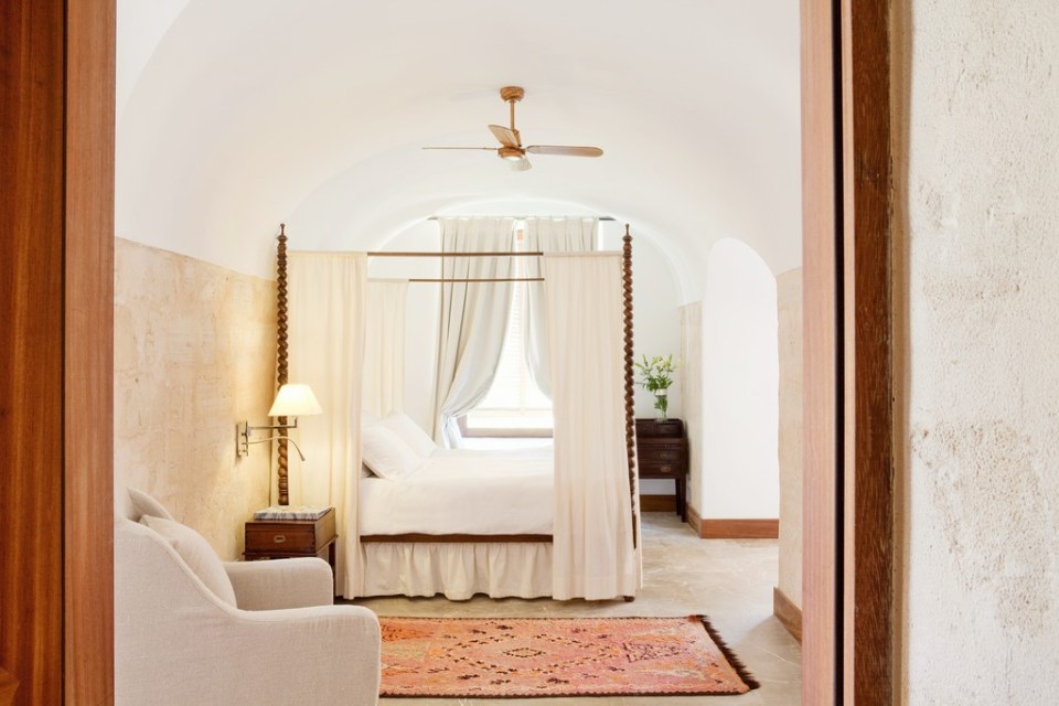 The bedroom follows a simple white colour scheme