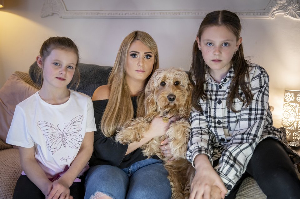 Mum Sophie Ponting and her children Holly, left, and Grace, right, say they've been told to get rid of their dog Luna