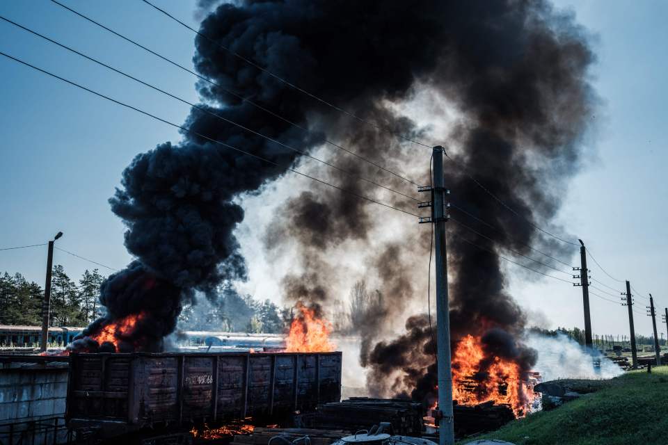 A rail wagon ablaze after shelling in Lyman, eastern Ukraine