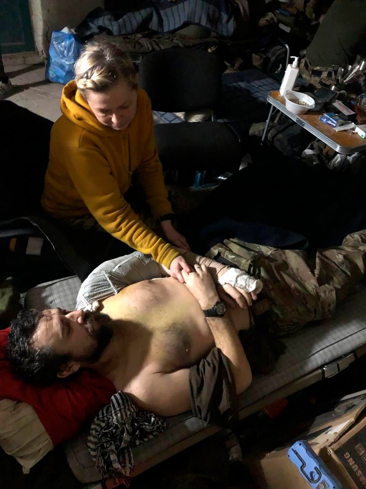 A woman comforting a wounded man holed up inside the Azovstal steel plant