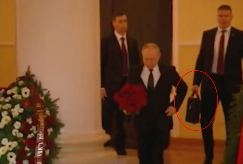 A man in a suit was seen carrying the alleged Russian nuclear briefcase