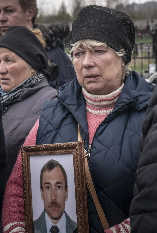 Natalia Maznychenko holding a portrait of her late husband, Vasyl Maznychenko 60