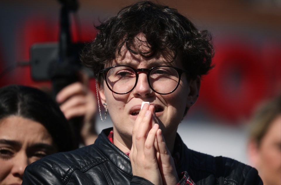 A fan cries as the cortege makes it way to St Francis of Assisi church