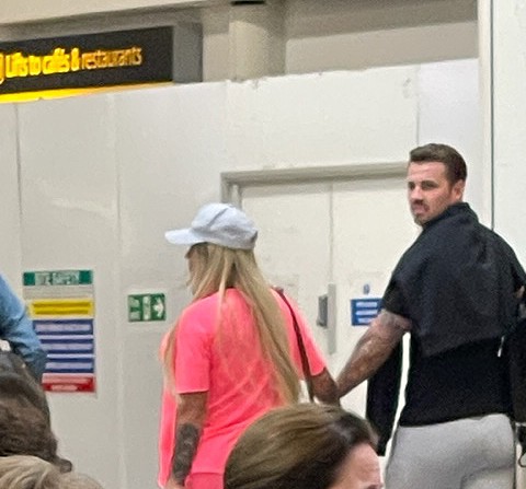 Katie and Carl were snapped holding hands at the airport