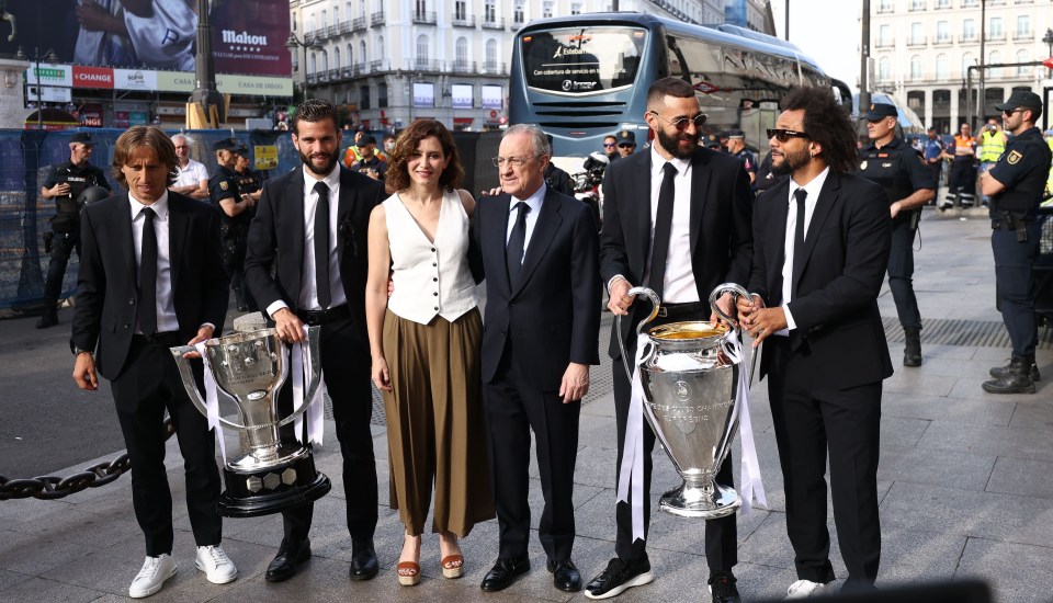 Modric, Nacho, Benzema and Marcelo alongside president Perez, the Champions League and LaLiga trophies