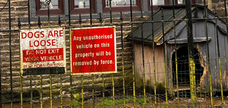 Signs outside the property warn 'dogs are loose'