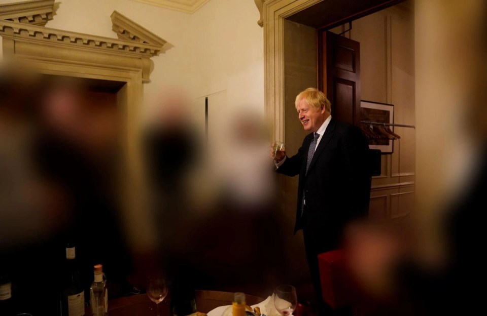 Boris Johnson holding a drink at a leaving part for a special adviser