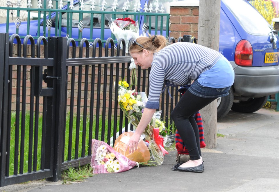 Well-wishers lay flowers at the scene after the incident