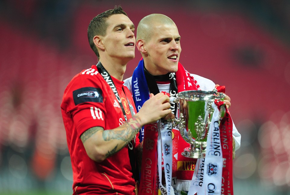 Liverpool’s Daniel Agger and Martin Skrtel (right) celebrate with the Carling Cup Trophy