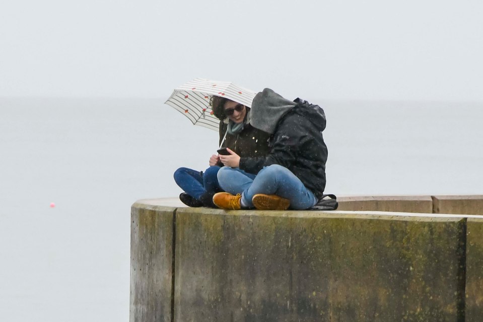 A couple at the seaside resort of West Bay in Dorset