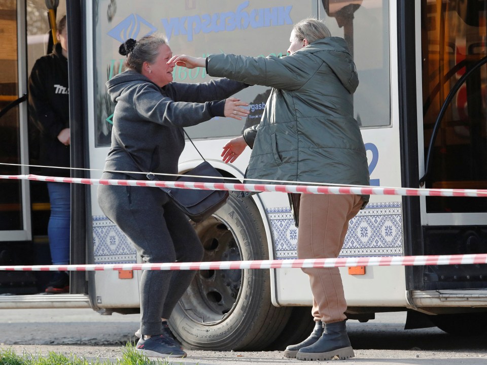 Two women hug each other following the evacuation