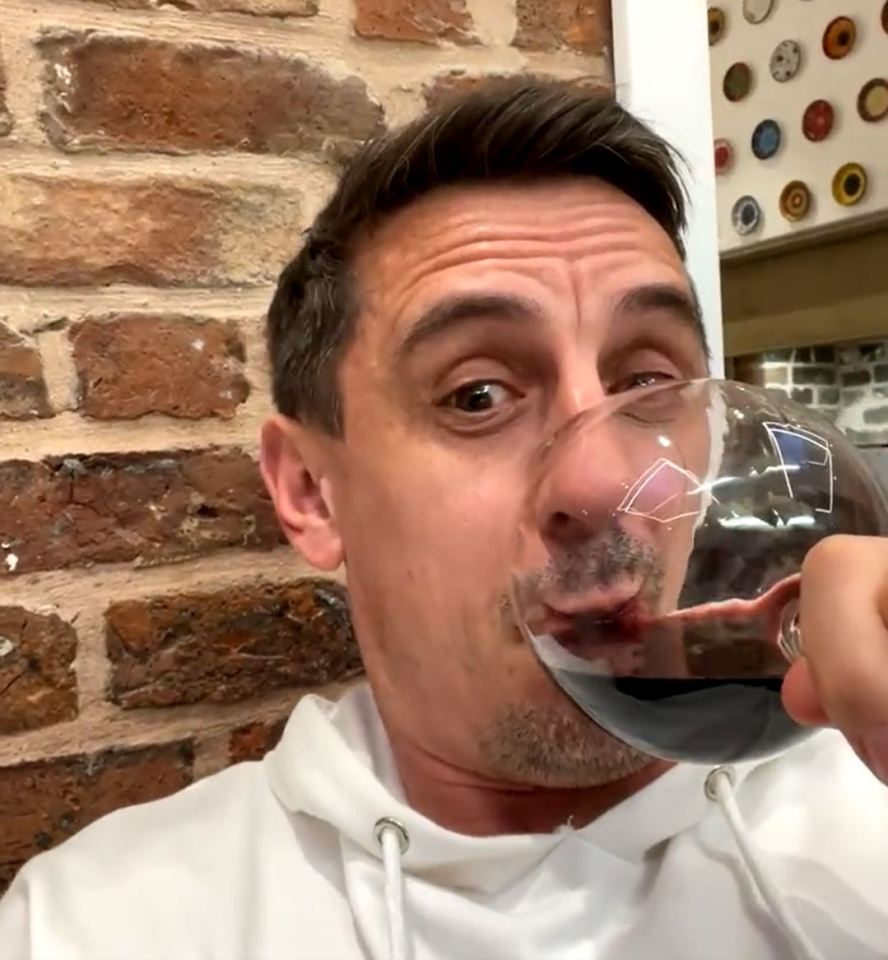 Gary neville excitedly sipped form his wine glass at half-time