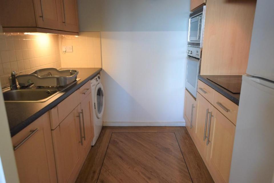 The flat has a modern fitted kitchen with electric oven and hob, microwave oven, fridge freezer, dishwasher and washer/dryer