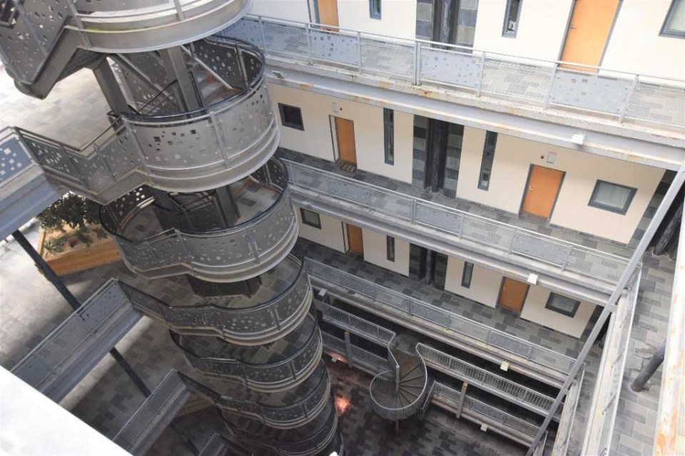 The spiral staircases and balconies resemble a prison