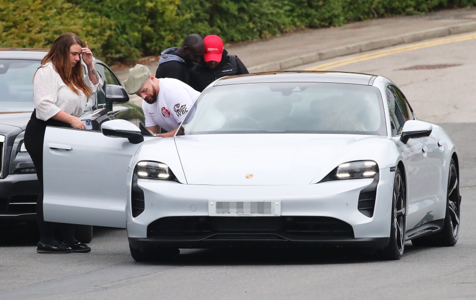 Fury steps into his £140,000 Porsche Taycan for the first time