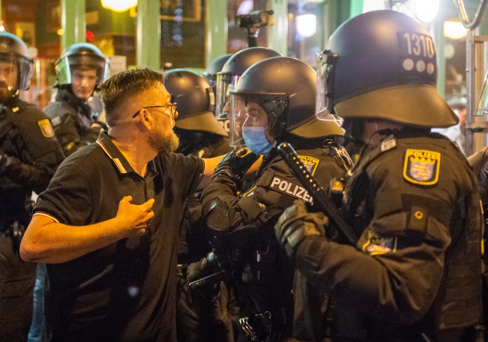 A West Ham fan tries to get past police to confront the thugs