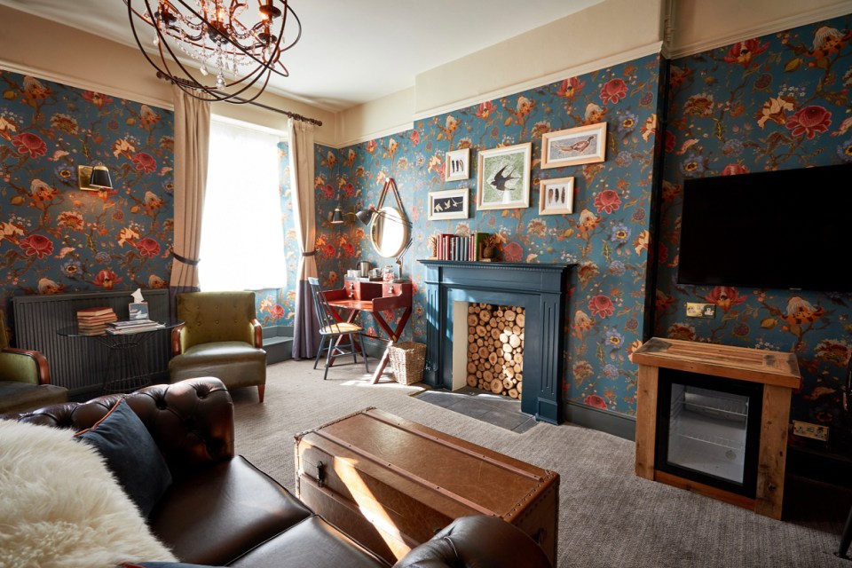 The Feature Room has a faux-leather sofa and eye-catching fittings, wallpaper and mirrors